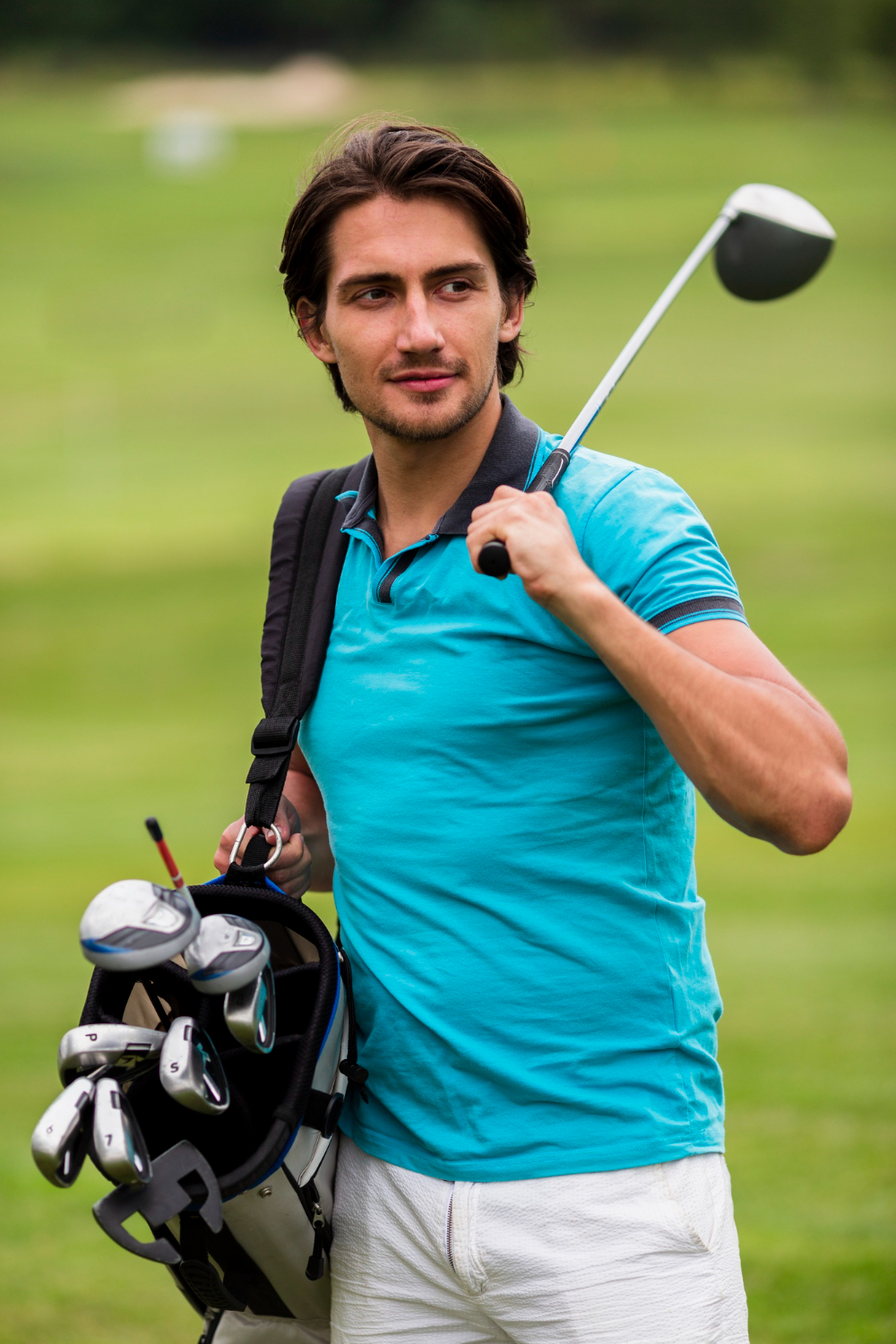 Golfer carrying clubs